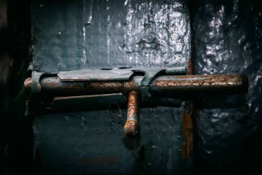 Eski Sovyet paslı demir retro mandalı boyalı ahşap bir kapının üzerinde.