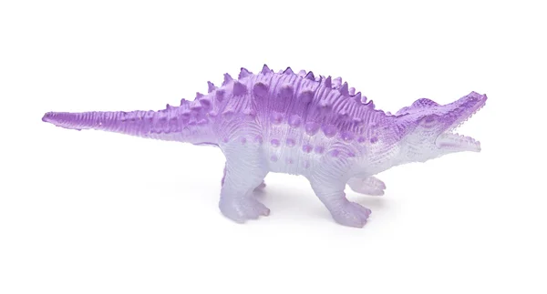 Jouet dinosaure en plastique lilas sur fond blanc — Photo