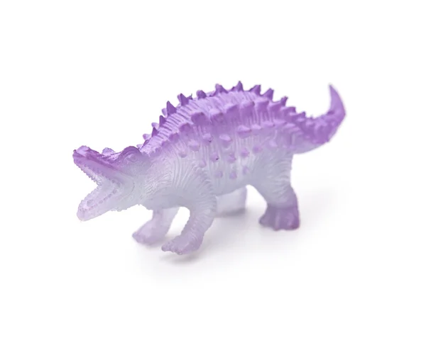 Lila plast dinosaurie leksak på en vit bakgrund — Stockfoto