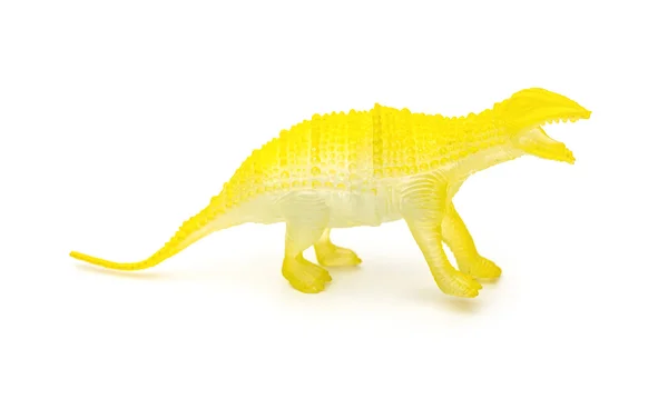 Gele kunststof dinosaurus speelgoed op een witte achtergrond — Stockfoto