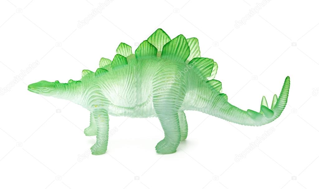 side view green stegosaurus toy on a white background