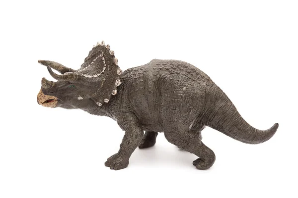 Vista lateral gris triceratops juguete sobre un fondo blanco — Foto de Stock