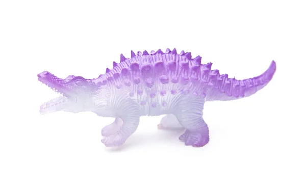 Vue de côté jouet de dinosaure en plastique violet sur fond blanc — Photo