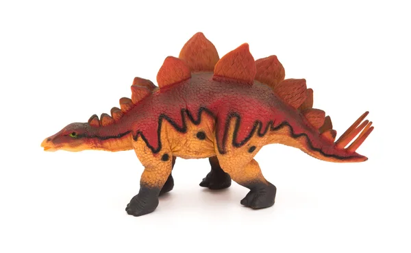 Vista lateral estegosaurio rojo juguete sobre un fondo blanco — Foto de Stock