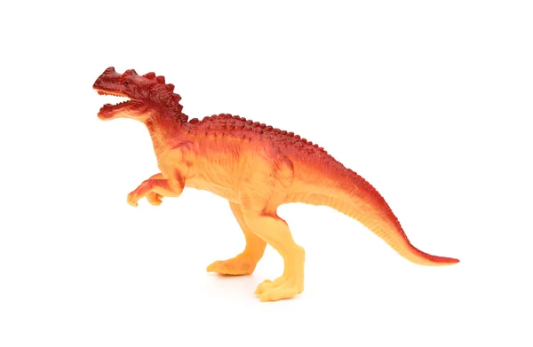 Vue de côté jouet de dinosaure en plastique orange sur fond blanc — Photo