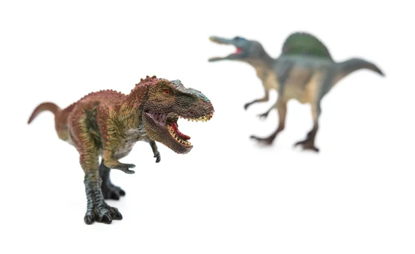 Tyrannosaurus en frente de spinosaurus en blanco enfoque selectivo —  Fotos de Stock