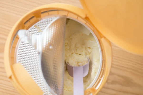 Can of powdered milk for children on wooden table close up — Stock Photo, Image