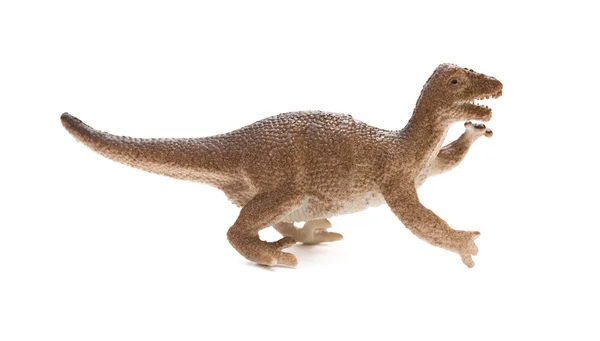 Vue de côté jouet dinosaure en plastique brun sur fond blanc — Photo