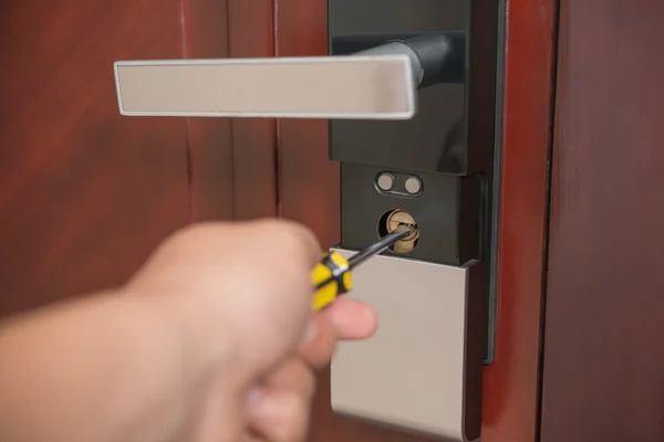Tentando abrir uma fechadura de porta por chave de fenda — Fotografia de Stock