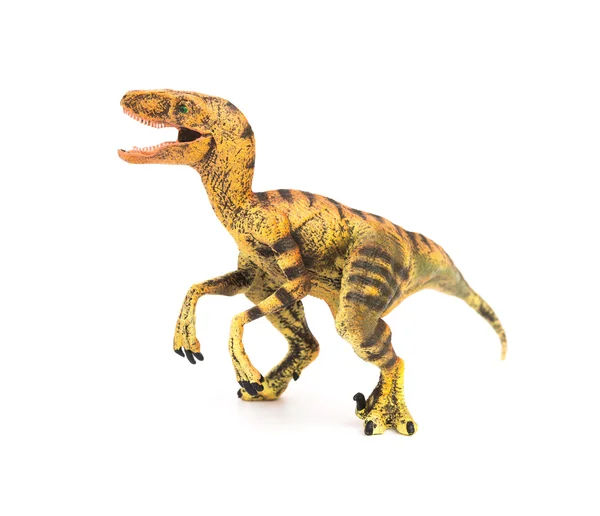 Kant weergave gele velociraptor speelgoed op een witte achtergrond — Stockfoto
