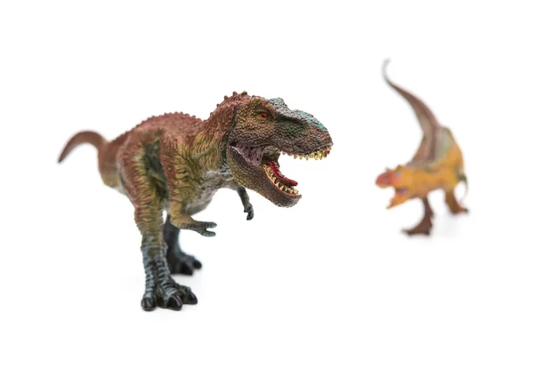 Tyrannosaurus in front of carnotaurus on white selective focus — Stock Photo, Image