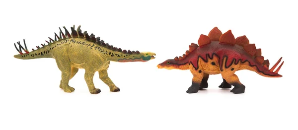 Gula huayangosaurus och röda stegosaurus leksaker på en vit bakgrund — Stockfoto