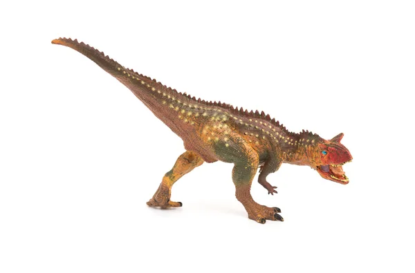 Seitenansicht braunes Carnotaurus-Spielzeug auf weißem Hintergrund — Stockfoto