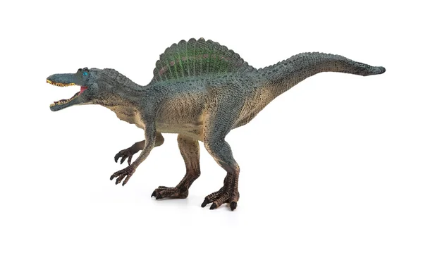 Vista lateral gris gris spinosaurus juguete sobre un fondo blanco —  Fotos de Stock