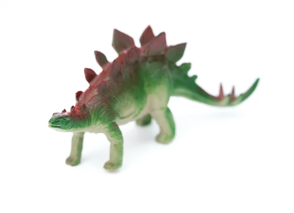 Gröna stegosaurus leksak på en vit bakgrund — Stockfoto