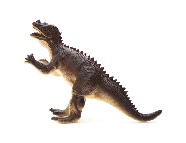 Juguete dinosaurio plástico marrón sobre un fondo blanco —  Fotos de Stock