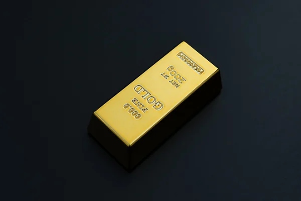 Piece of gold bar on a black background — Stock Photo, Image
