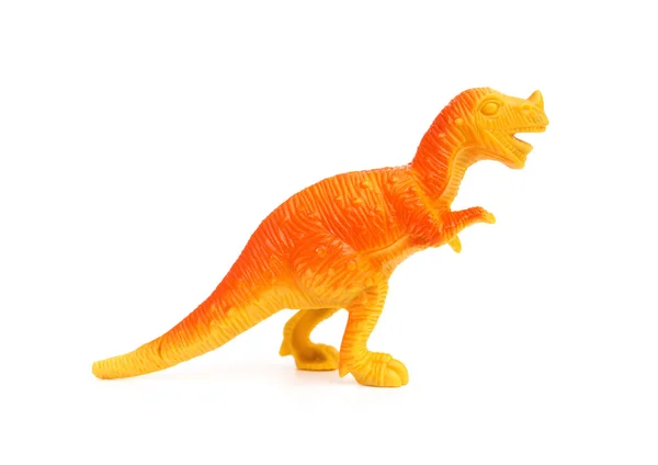 Juguete dinosaurio plástico naranja vista lateral sobre un fondo blanco — Foto de Stock