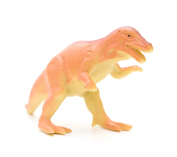 Juguete dinosaurio plástico naranja sobre un fondo blanco — Foto de Stock