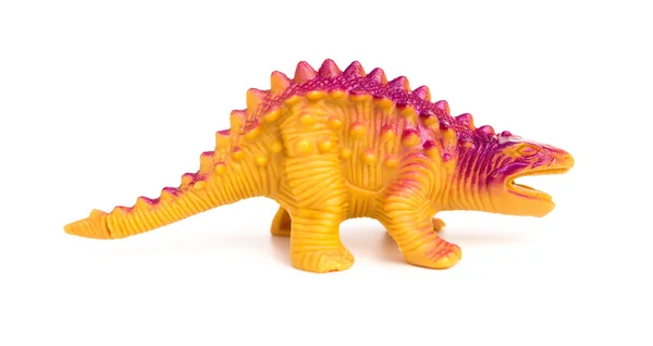Jouet de dinosaure en plastique orange sur fond blanc — Photo