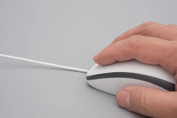 Man using a white mouse on a grey background close up — Stock Photo, Image