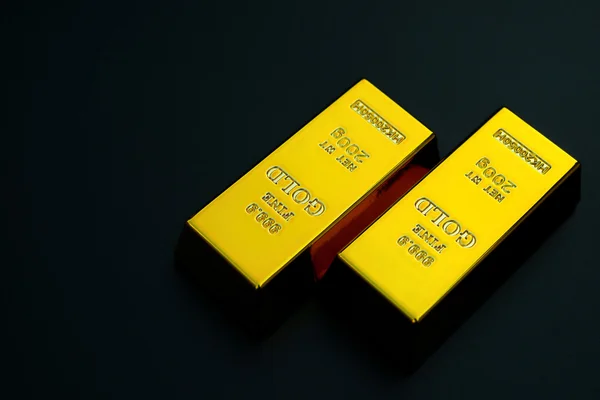 Two pieces of gold bar on a black background — Stock Photo, Image