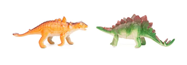 Gröna stegosaurus och orange pinacosaurus leksak på en vit bakgrund — Stockfoto