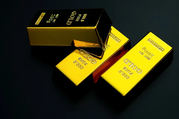 Three pieces of gold bar on a black background — Stock Photo, Image