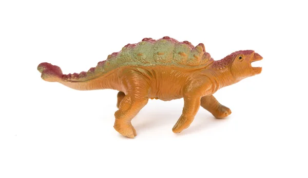 Kant weergave bruin plastic dinosaurus speelgoed op een witte achtergrond — Stockfoto