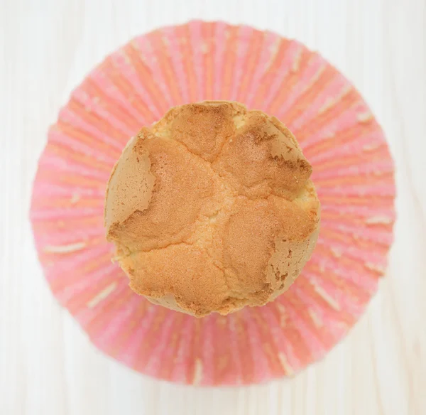 Top view homemade cup cake with the outer opened on a wood background — Stock Photo, Image