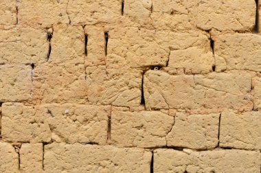Arka plan ve doku olarak çamur tuğlalarından yapılmış duvar