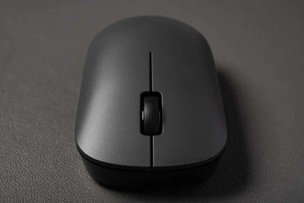 front view black wireless mouse on a dark background