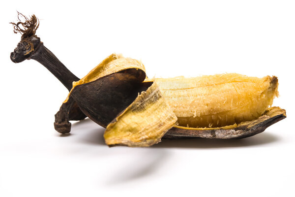 Peeled overripe banana on a white background