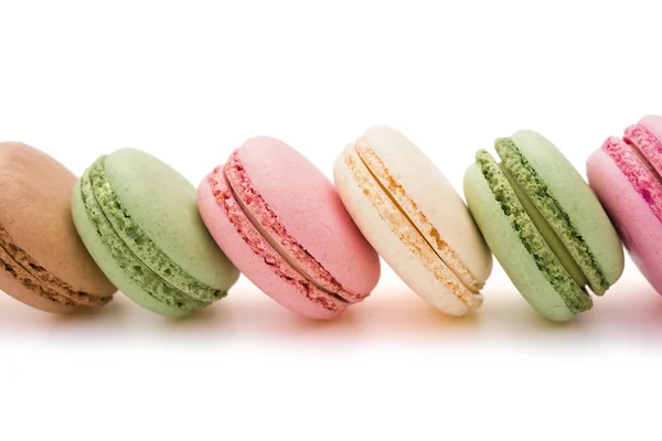 Colorful macaroons line up on white with clipping path — Stock Photo, Image