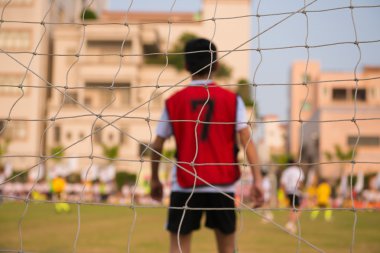 Amaç, bir goaltender ve diğer oyuncular arka planda kumaşı