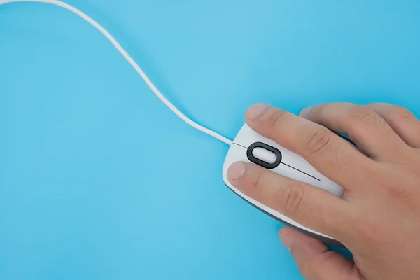 Man using a black mouse on blue — Stock Photo, Image