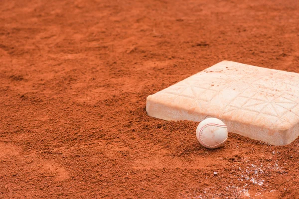 Baseball and base on baseball field — Stock Photo, Image