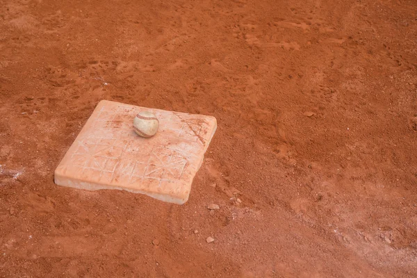 Baseball and base on baseball field — Stock Photo, Image