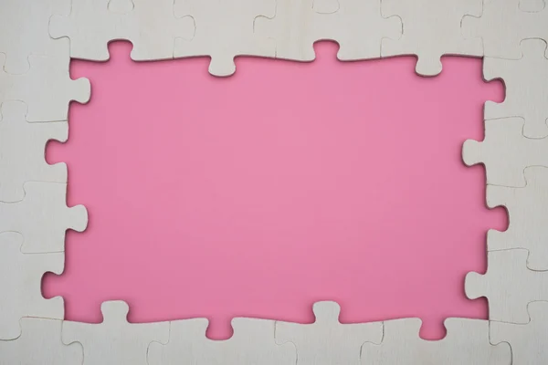 분홍색 배경에 framp 모양 직소 퍼즐 — 스톡 사진