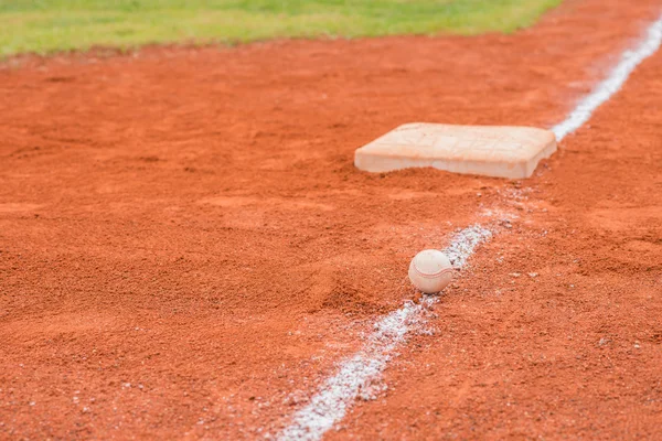 Baseball and base on baseball field — Stock Photo, Image