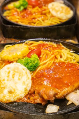 cooking steak spaghetti at vertical composition