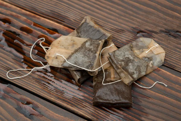 Used teabags on a wooden background — Stock Photo, Image