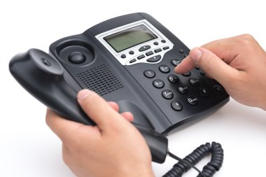 man dialing a black telephone on a white background clipart