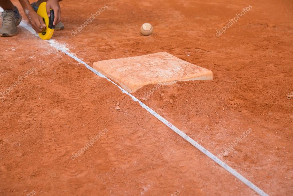 Measuring the base distance of a baseball field Stock Photo by
