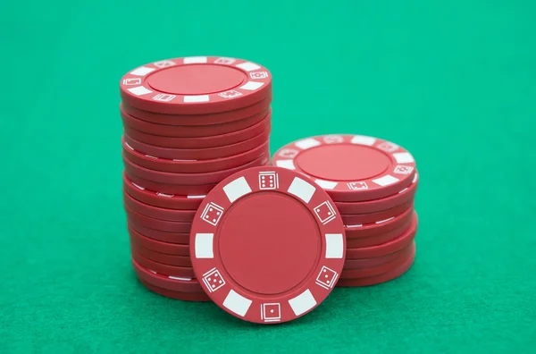 Lots of red poker chips on casino table — Stock Photo, Image