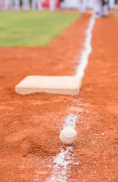 Baseball and base on baseball field — Stock Photo, Image