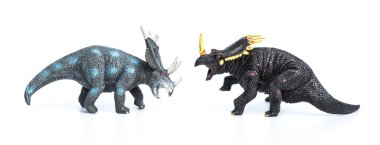 styracosaurus and triceratops toys on a white background clipart