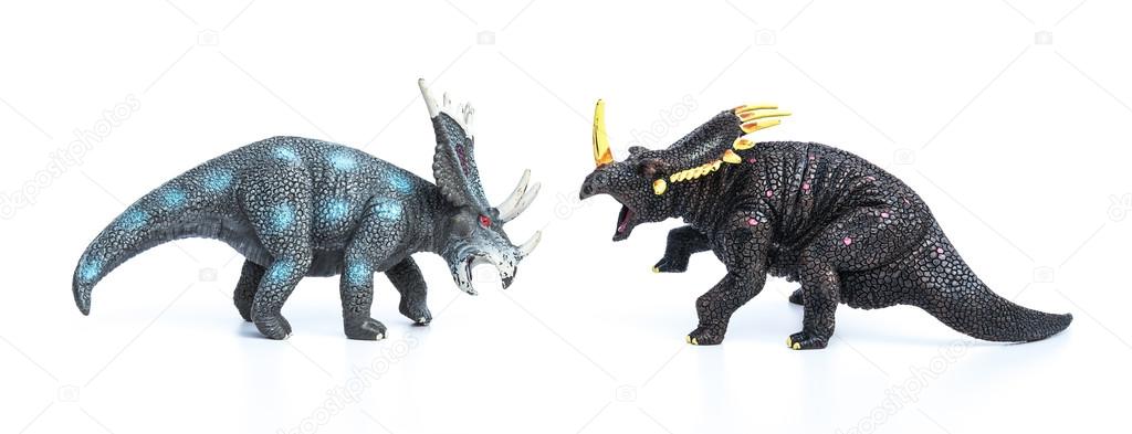 styracosaurus and triceratops toys on a white background