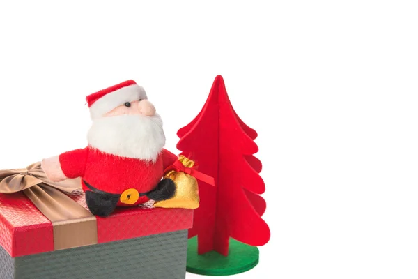 Santa claus sitting on present box with christmas tree on white — Stock Photo, Image