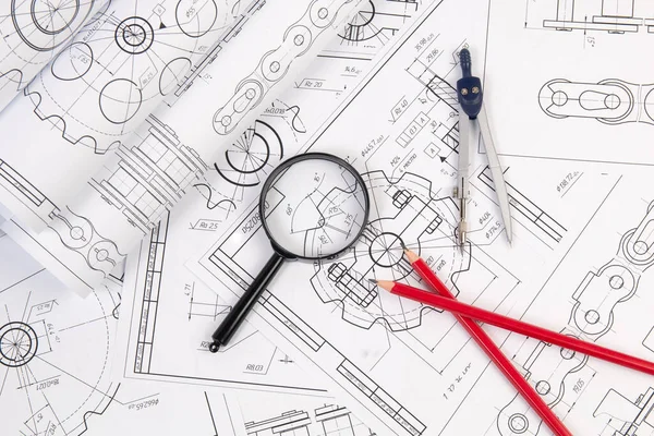 Industrial chain drawings, engineering compass, magnifying glass and pencils